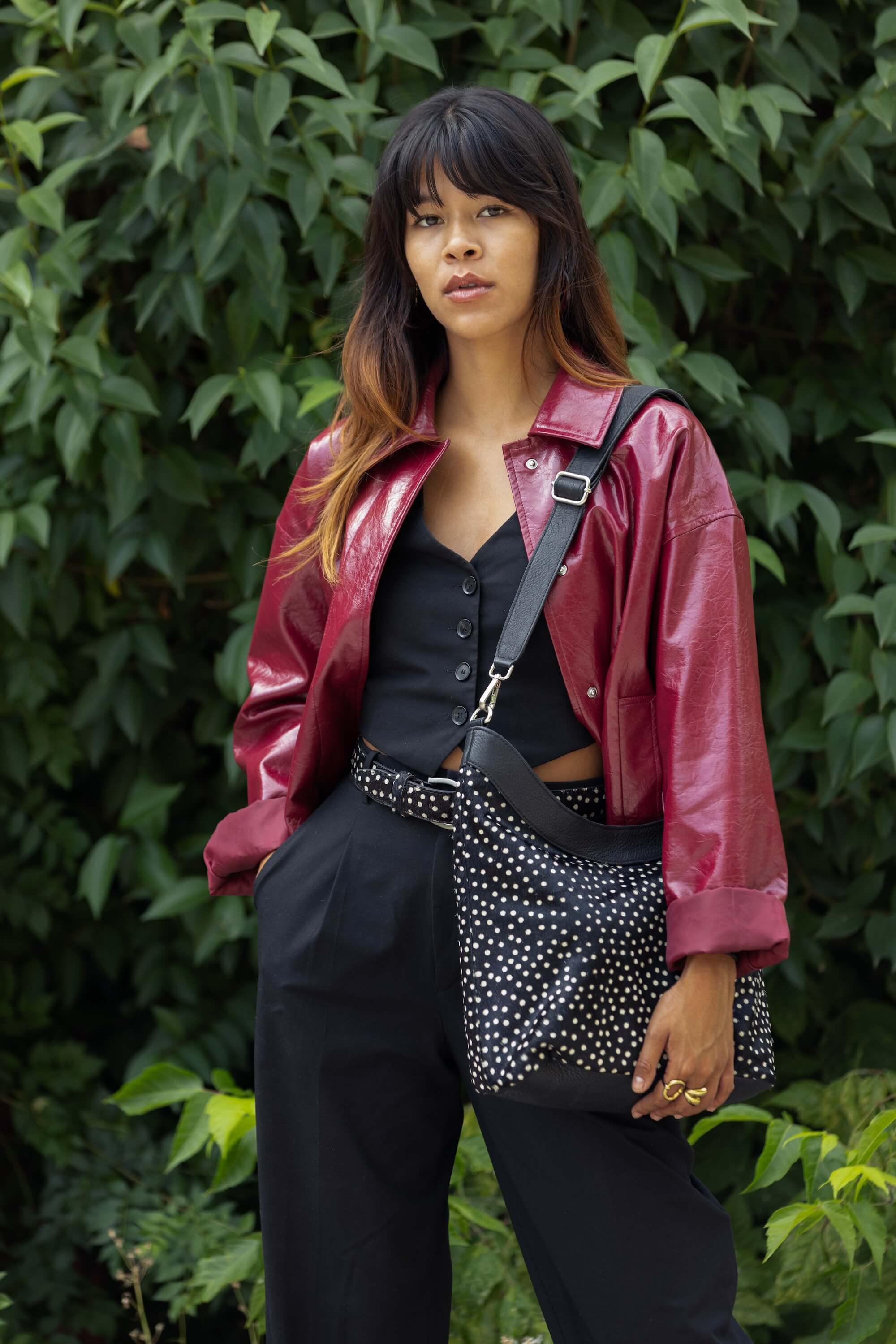 Photo lifestyle du sac hobo Alice Fauve de Charlay Stone en cuir pony animalier imprimé noir à pois blanc.